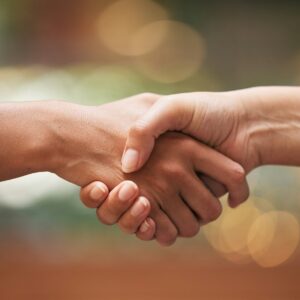 Handshake, closeup and partnership for contract, agreement and teamwork. Trust, support and shaking